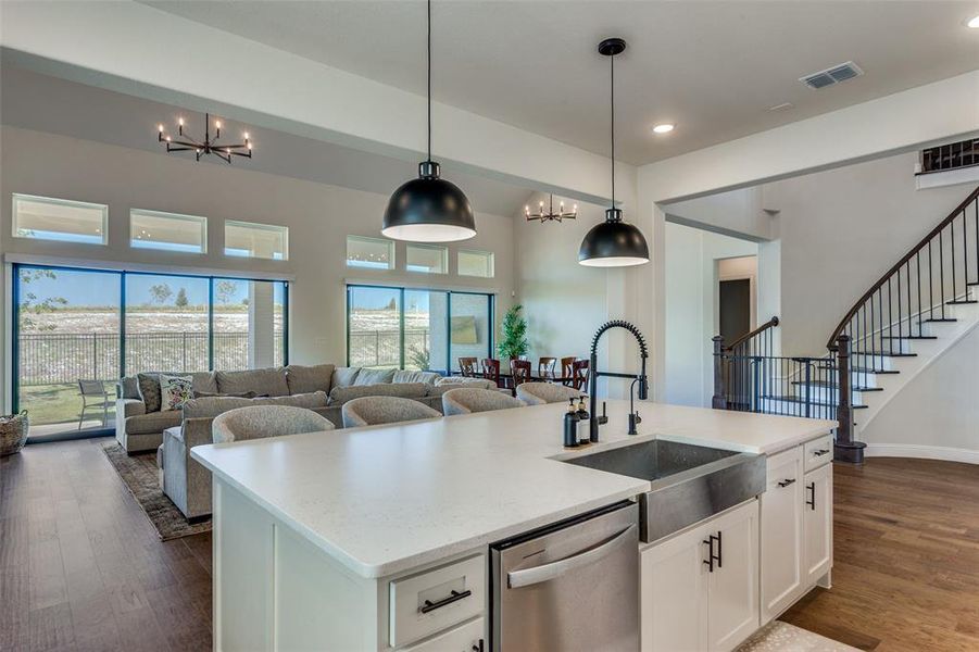 Kitchen featuring a chandelier, white cabinetry, dishwasher, dark wood-style flooring, and recessed lighting Kitchen featuring a chandelier, white cabinetry, dishwasher, dark wood-style flooring, and recessed lighting
