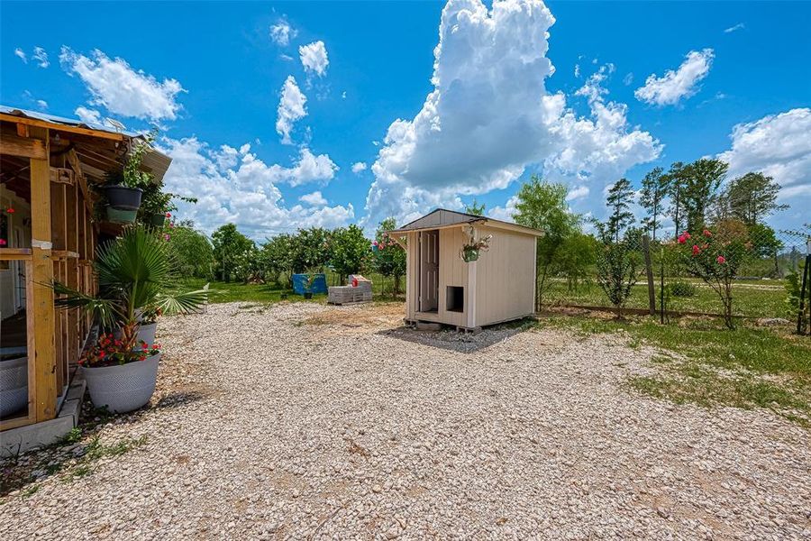 Outside the home, a well-organized utility area provides convenient access to essential services, featuring a practical layout for tasks such as gardening, and tool storage, all while maintaining the home's neat and tidy appearance.