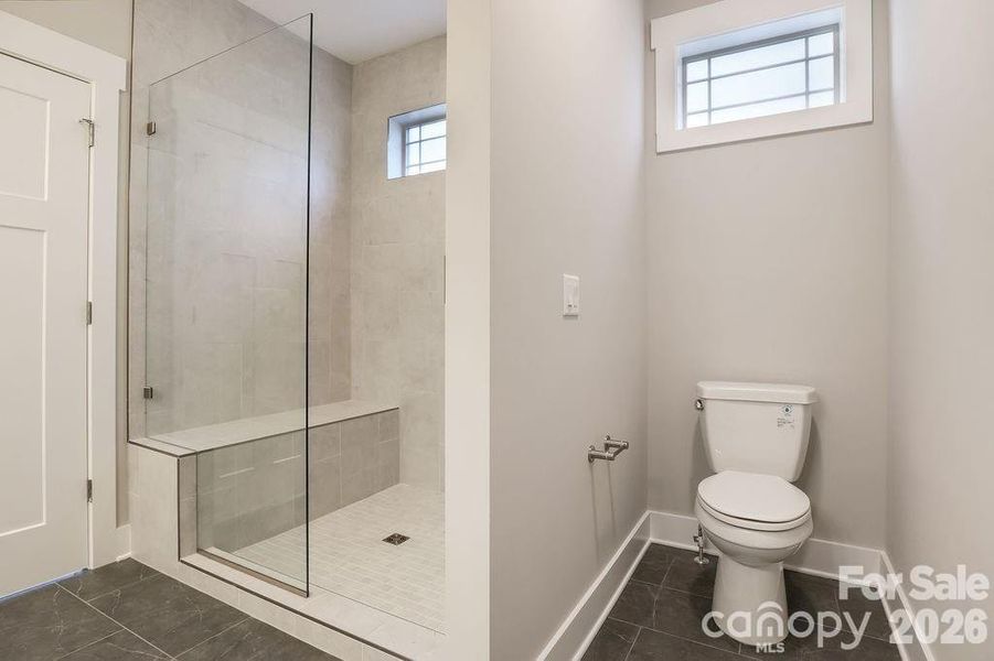 Primary suite low profile entry shower with tile surround. Similar model home. Primary suite low profile entry shower with tile surround. Similar model home.