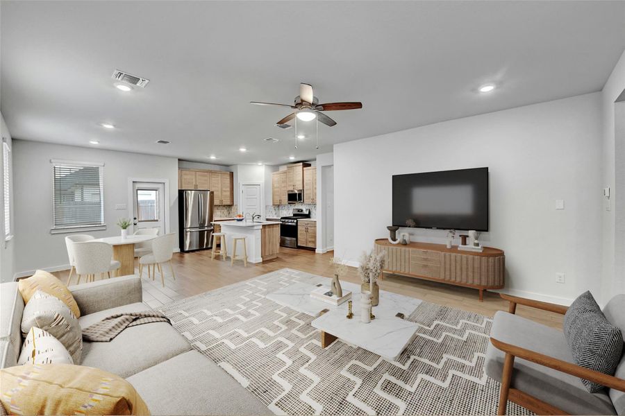 Living room featuring ceiling fan, recessed lighting, and light wood finished floors Living room featuring ceiling fan, recessed lighting, and light wood finished floors