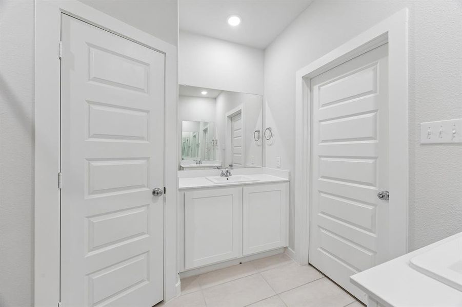 Primary Bathroom in the Cedar home plan by Trophy Signature Homes – REPRESENTATIVE PHOTO