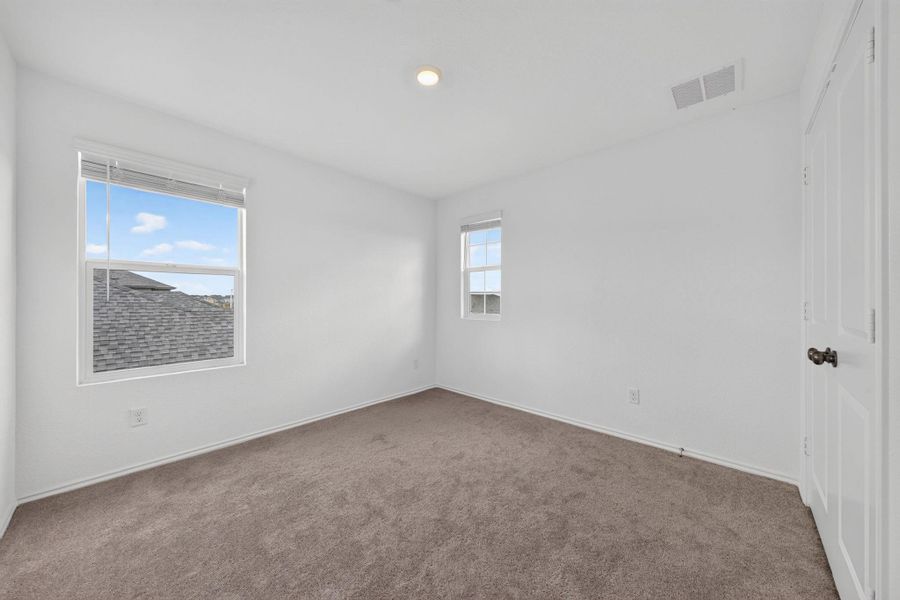 A well-lit, neutral-toned room provides a versatile space, featuring two distinct windows for ample natural light. A well-lit, neutral-toned room provides a versatile space, featuring two distinct windows for ample natural light.
