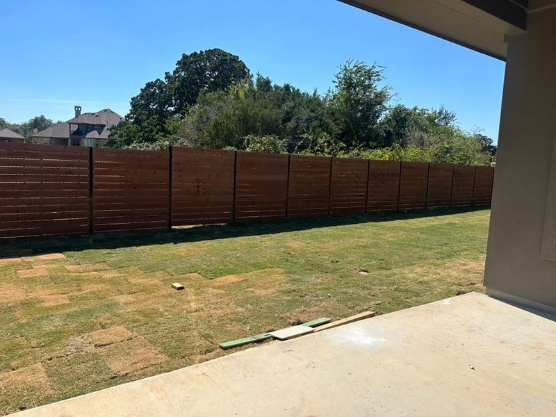 Fenced backyard featuring a patio area Fenced backyard featuring a patio area