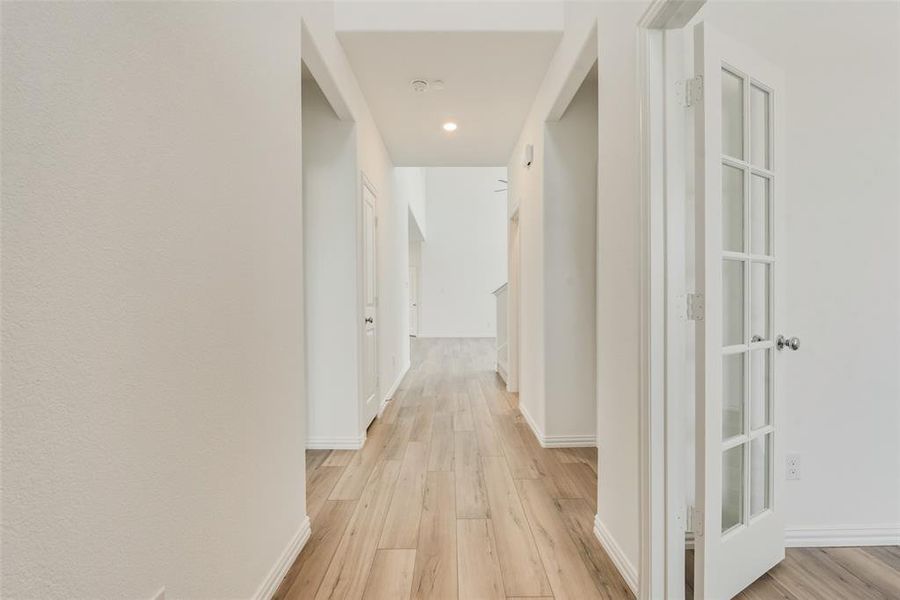 Corridor featuring light wood-type flooring