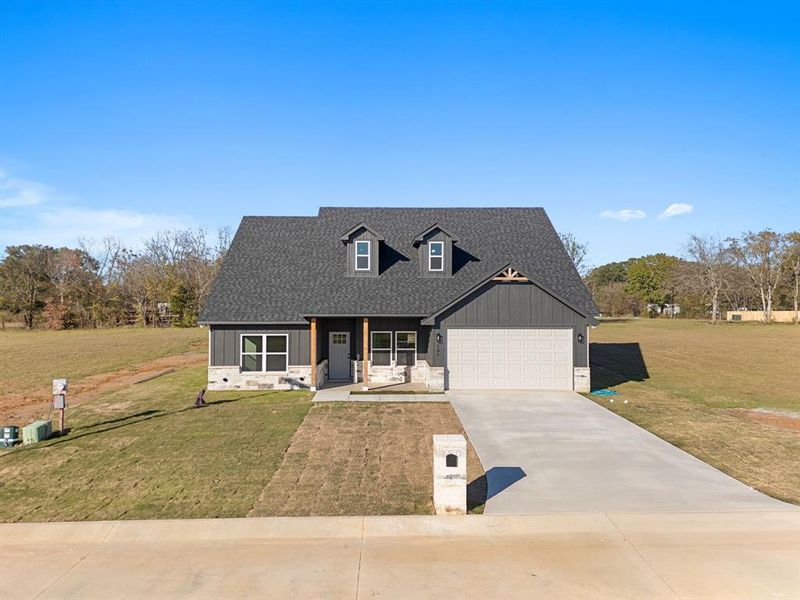 Front exterior of a new home in , Troup, TX, highlighting curb appeal (Image 1).