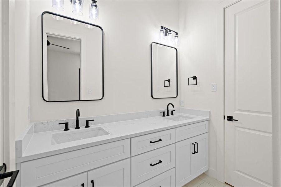 Bathroom vanity with double sinks are shared by two of the bedrooms.