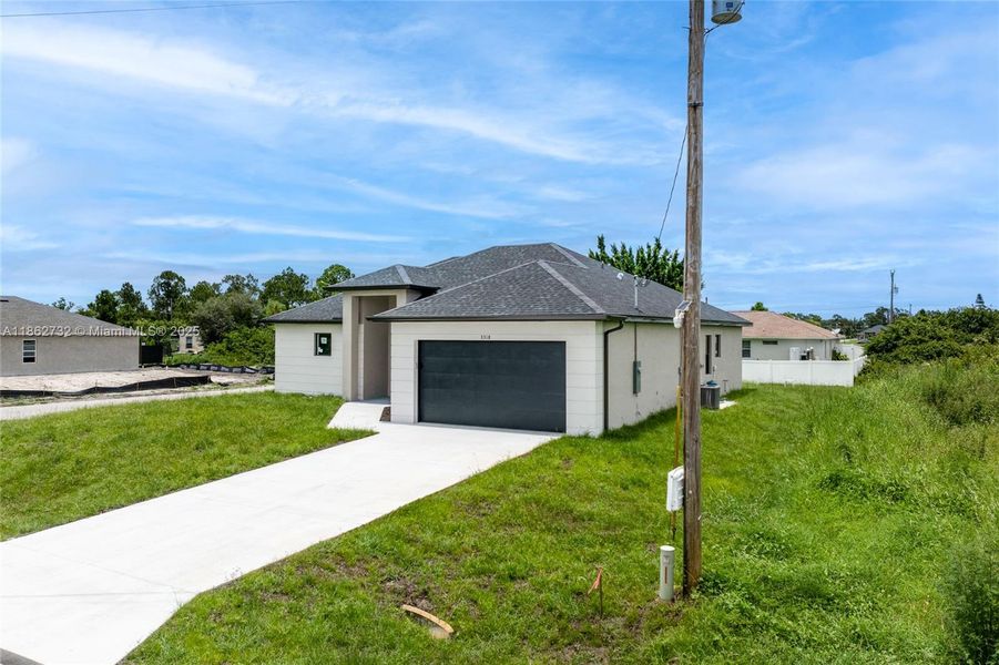 Front exterior of a new home in , Lehigh Acres, FL, highlighting curb appeal (Image 2). Front exterior of a new home in , Lehigh Acres, FL, highlighting curb appeal (Image 2).