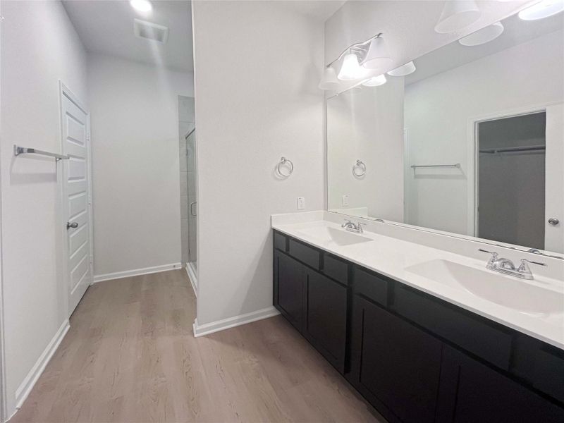 Owner's Bathroom with Dual Sinks and Walk-in Shower. Home under construction. Sample floor plan photo used for illustrative purposes only. Upgrades, selections options, windows and colors may vary.