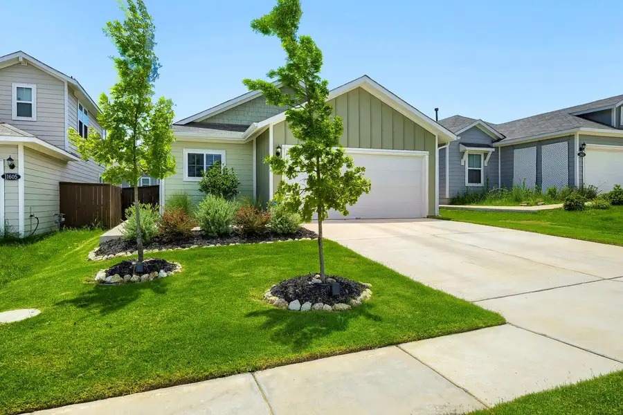A neatly maintained front yard with thriving trees and shrubs frames this inviting residence. A neatly maintained front yard with thriving trees and shrubs frames this inviting residence.