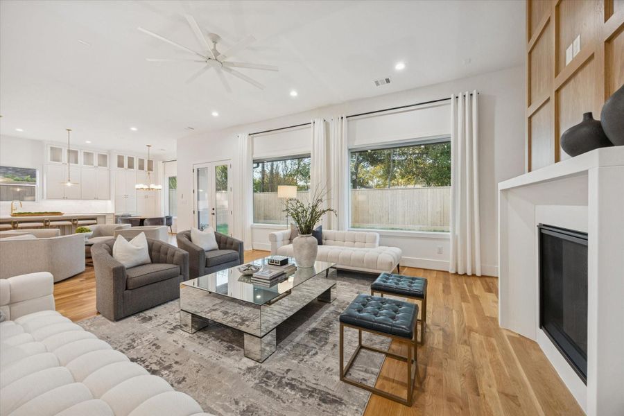 Wide sightlines connect the living room to the kitchen and backyard, creating a layout that supports both everyday routines and larger gatherings. Oversized windows, high ceilings, and direct outdoor access keep the space light filled while maintaining a comfortable, livable scale. Wide sightlines connect the living room to the kitchen and backyard, creating a layout that supports both everyday routines and larger gatherings. Oversized windows, high ceilings, and direct outdoor access keep the space light filled while maintaining a comfortable, livable scale.