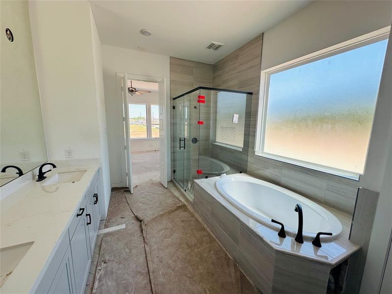 Private primary bath with tub and shower.