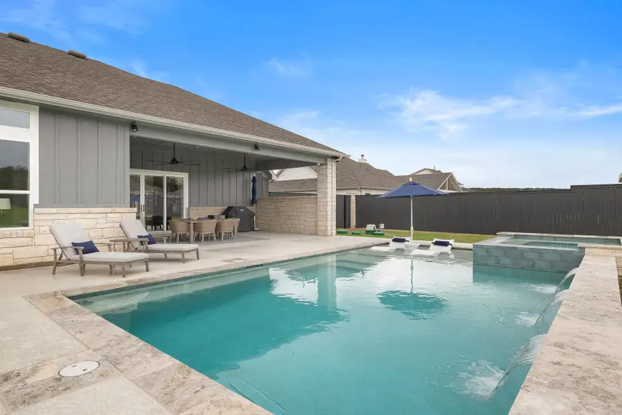 Resort-style pool with tanning ledge and plenty of space to lounge.