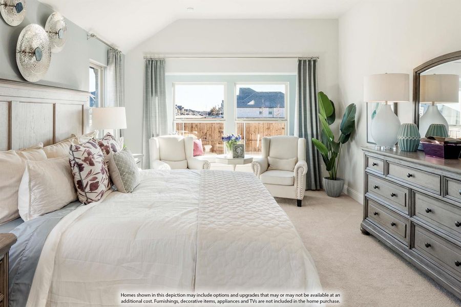 Master bedroom with vaulted ceiling, king bed, sitting area, and large windows with natural light