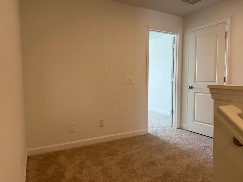 Staircase opens up onto versatile second-floor loft space