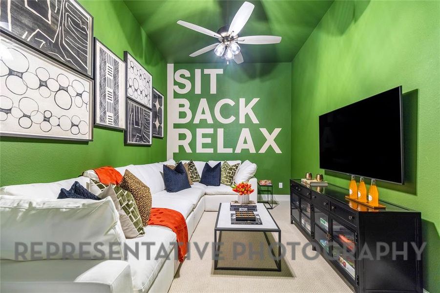 Carpeted living area with ceiling fan Carpeted living area with ceiling fan