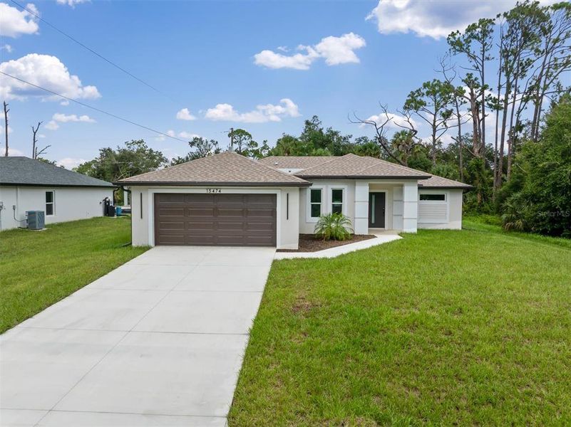 Front exterior of a new home in , Port Charlotte, FL, highlighting curb appeal (Image 1). Front exterior of a new home in , Port Charlotte, FL, highlighting curb appeal (Image 1).