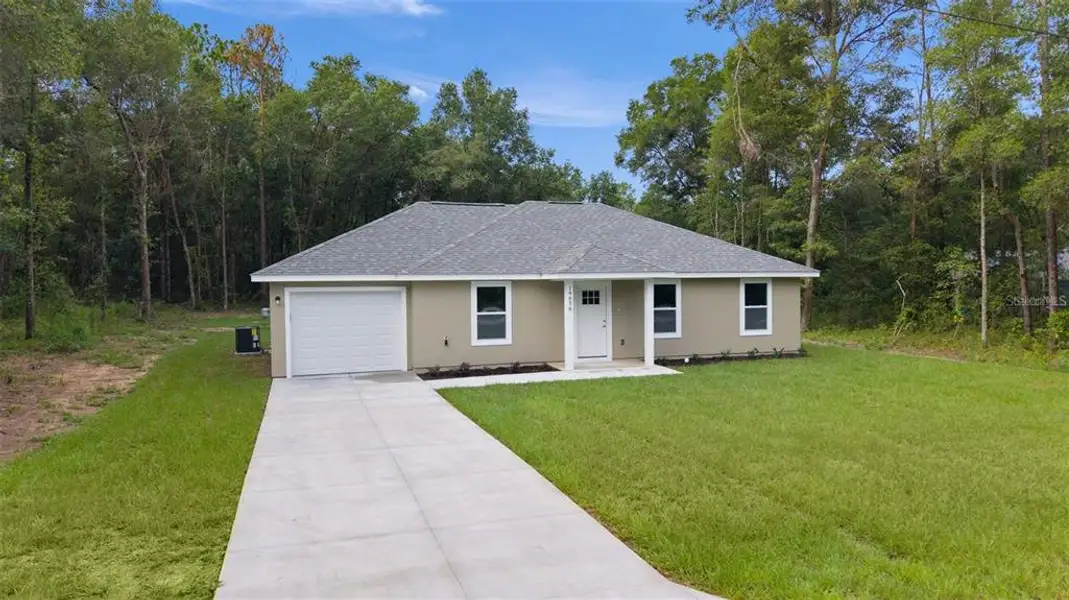 Front exterior of a new home in , Ocklawaha, FL, highlighting curb appeal (Image 1). Front exterior of a new home in , Ocklawaha, FL, highlighting curb appeal (Image 1).