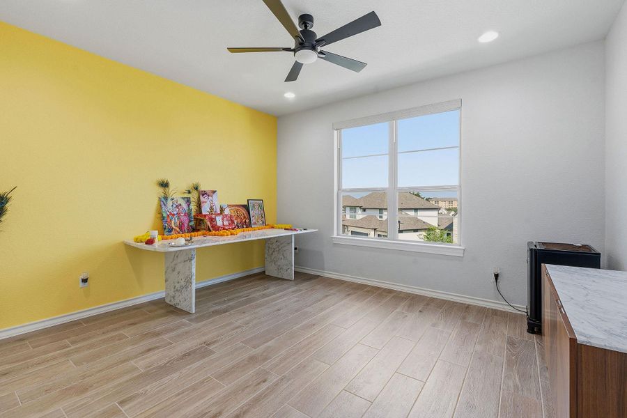 A well-lit room showcases durable tile flooring and a refreshing ceiling fan. A well-lit room showcases durable tile flooring and a refreshing ceiling fan.