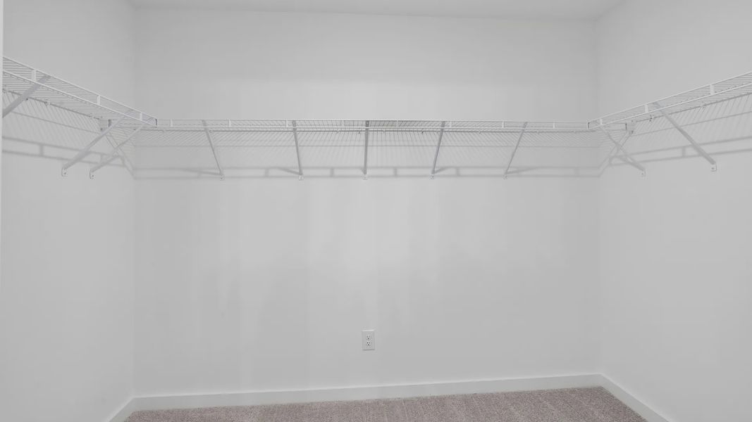 Spacious walk-in closet for primary suite Spacious walk-in closet for primary suite