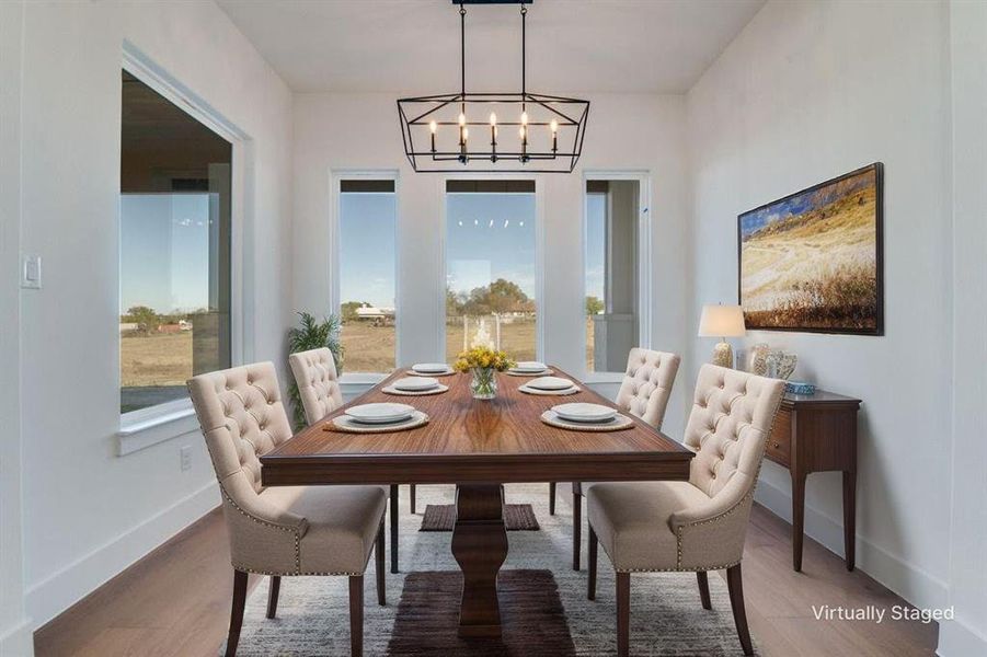 Dining space featuring wood finished floors and a chandelier