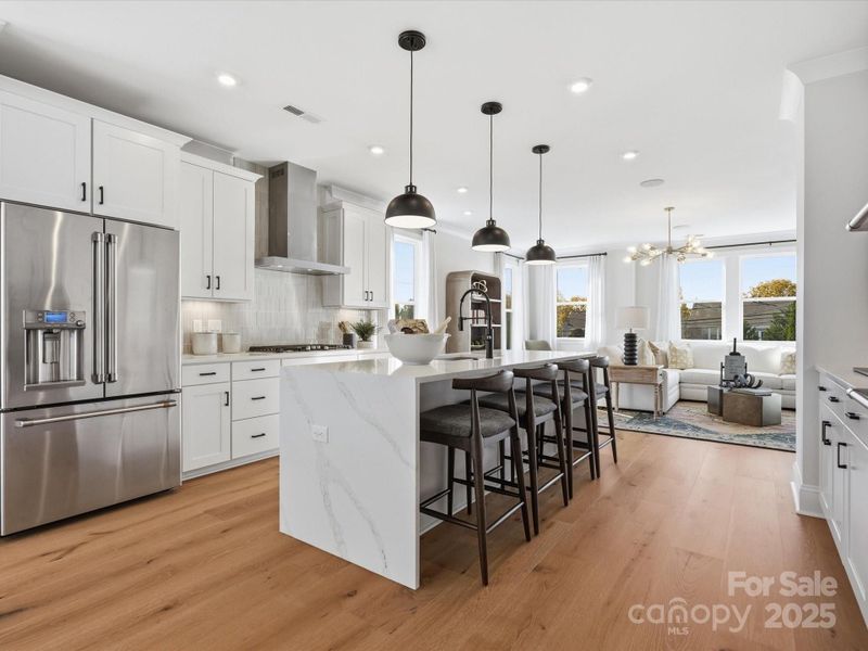 Quartz Countertops at Large Central Island. *Model Photos | Actual Finishes, Structural Selections, and Orientation May Vary. Quartz Countertops at Large Central Island. *Model Photos | Actual Finishes, Structural Selections, and Orientation May Vary.