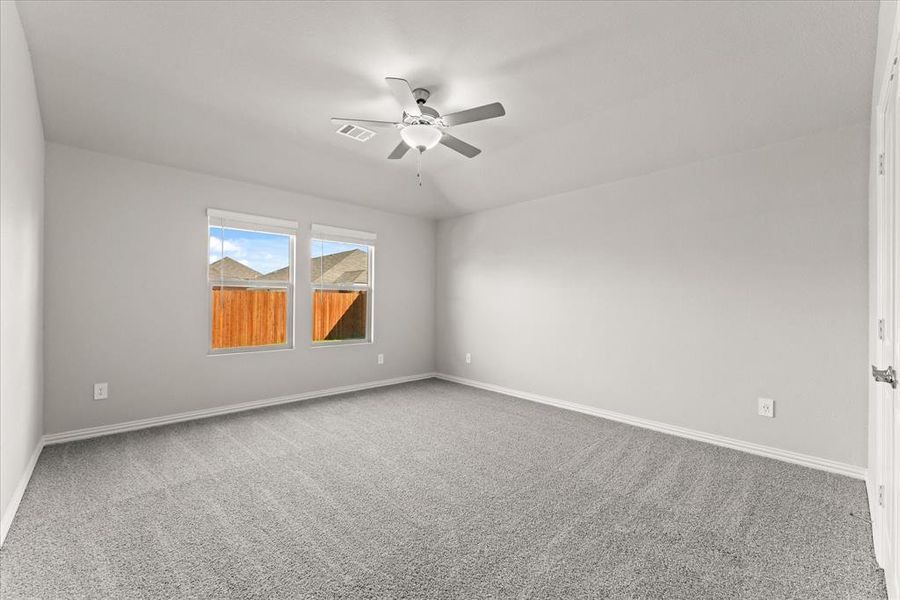 Spare room featuring ceiling fan and carpet floors