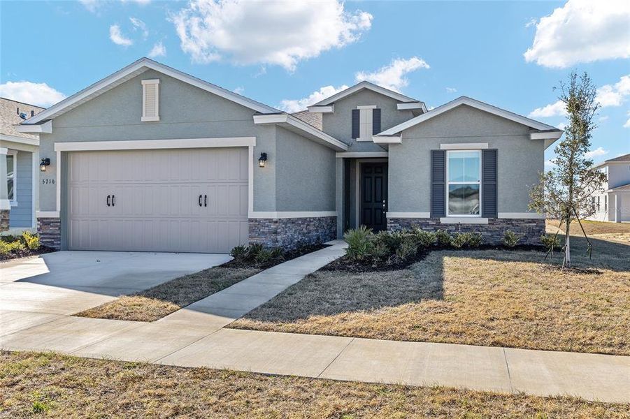 Front exterior of a new home in Calesa Township, Ocala, FL, highlighting curb appeal (Image 20).