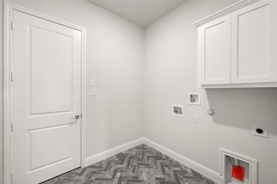 Washroom with cabinet space, hookup for an electric dryer, washer hookup, and hookup for a gas dryer Washroom with cabinet space, hookup for an electric dryer, washer hookup, and hookup for a gas dryer