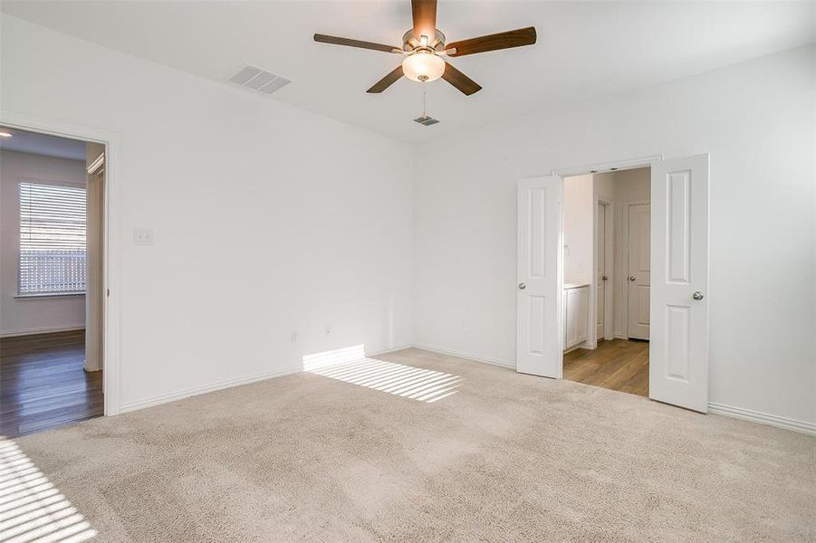 Empty room featuring ceiling fan and light hardwood / wood-style flooring