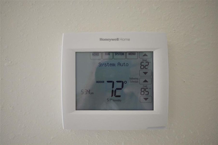 Programable Honeywell thermostat aids in saving energy and keeping the home comfortable.