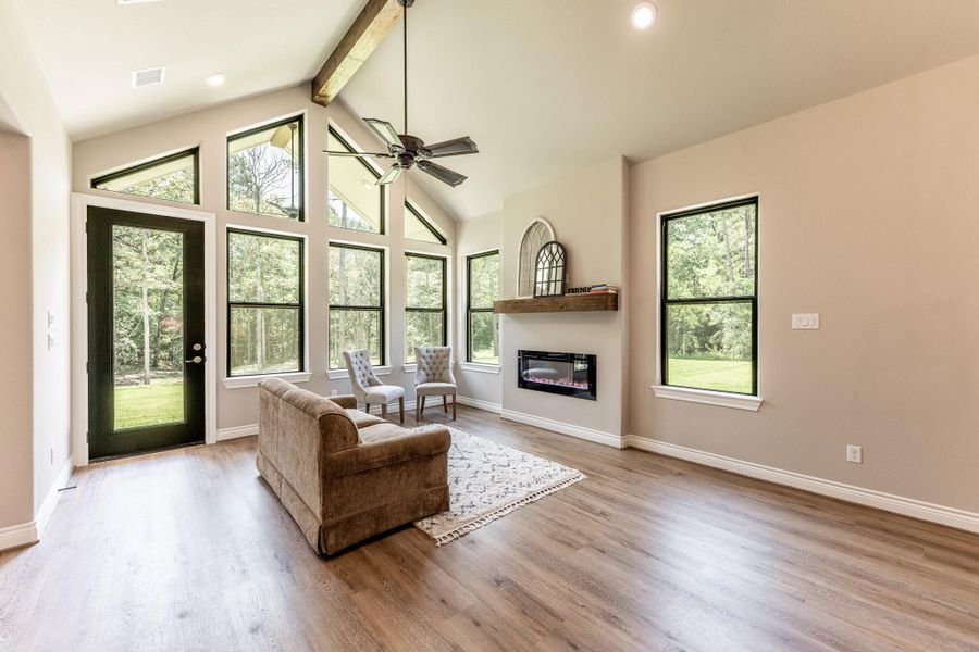 This guest house also has living area with electric fireplace, vinyl plank flooring and door leading to its own covered back porch