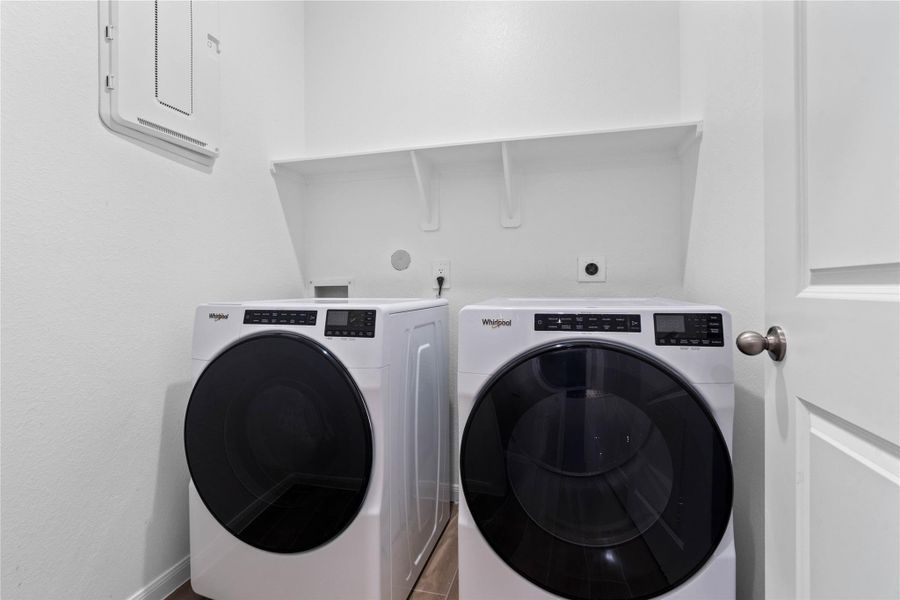 This dedicated laundry room comes equipped with a washer and dryer set, ready for immediate use