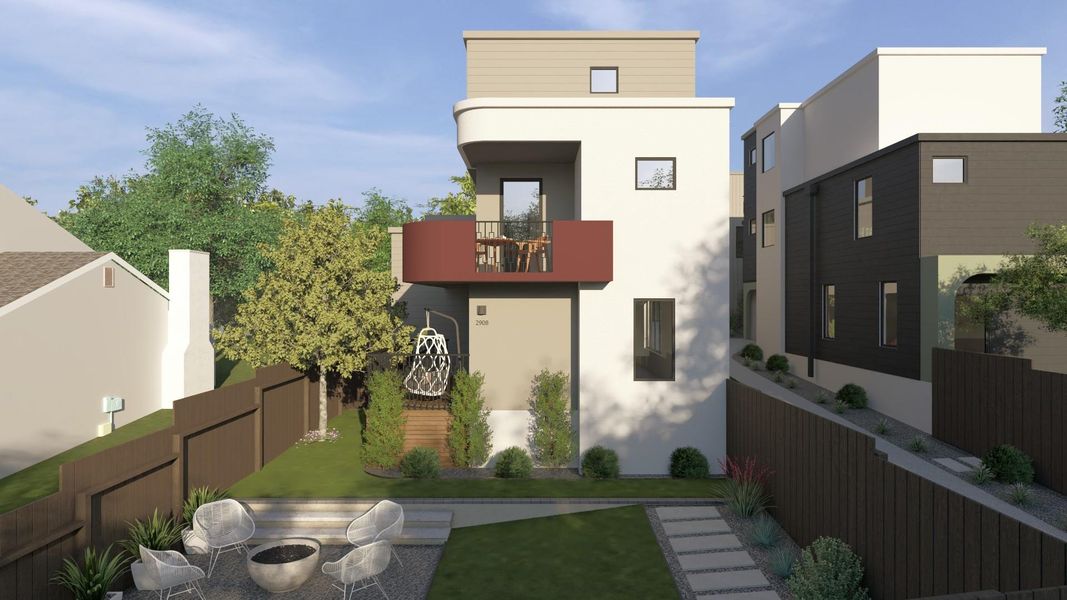 Rear view of house featuring a balcony, a fenced backyard, and stucco siding