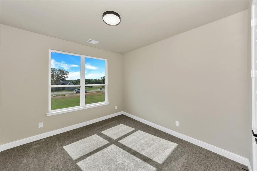 Spare room featuring carpet flooring