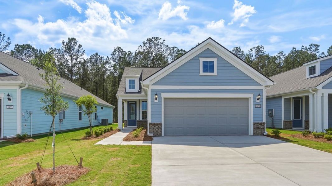 Front exterior of a new home in Sun City Hilton Head, Bluffton, SC, highlighting curb appeal (Image 1). Front exterior of a new home in Sun City Hilton Head, Bluffton, SC, highlighting curb appeal (Image 1).