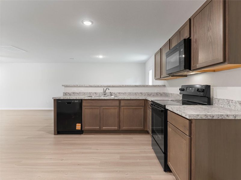 Stunning kitchen featuring sleek black appliances for a modern touch.