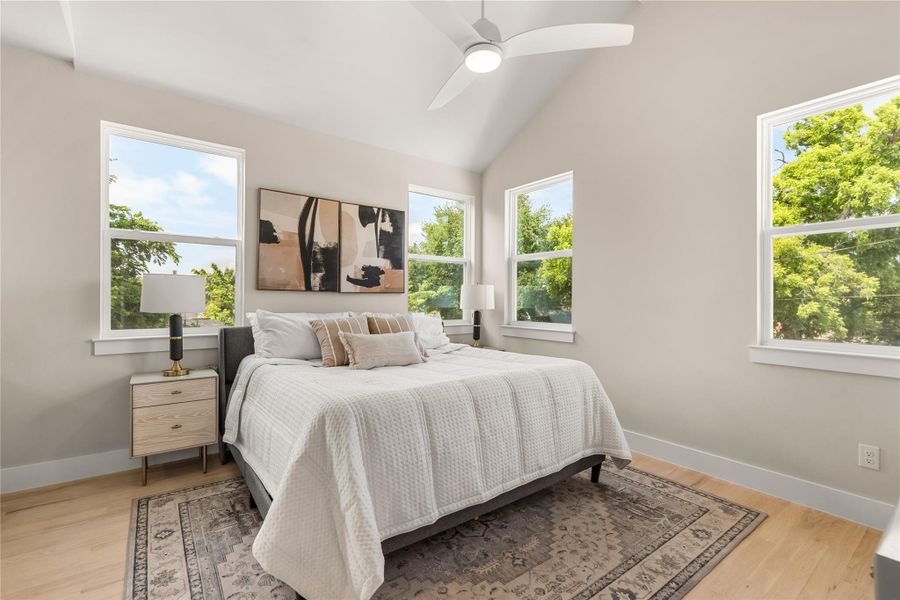 Expansive primary suite with cathedral ceilings, abundant natural light & enough space for a cozy sitting area, creating the perfect retreat at the end of the day.