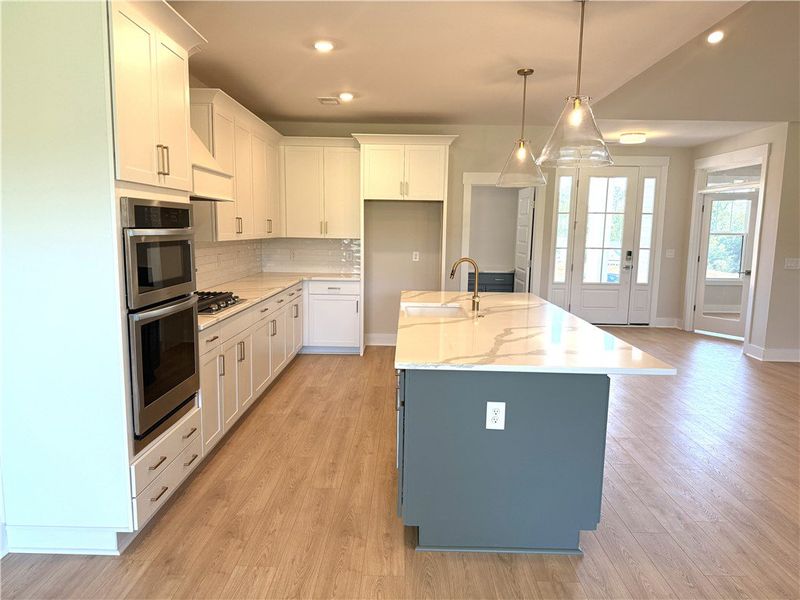 This bright kitchen features an expansive island a