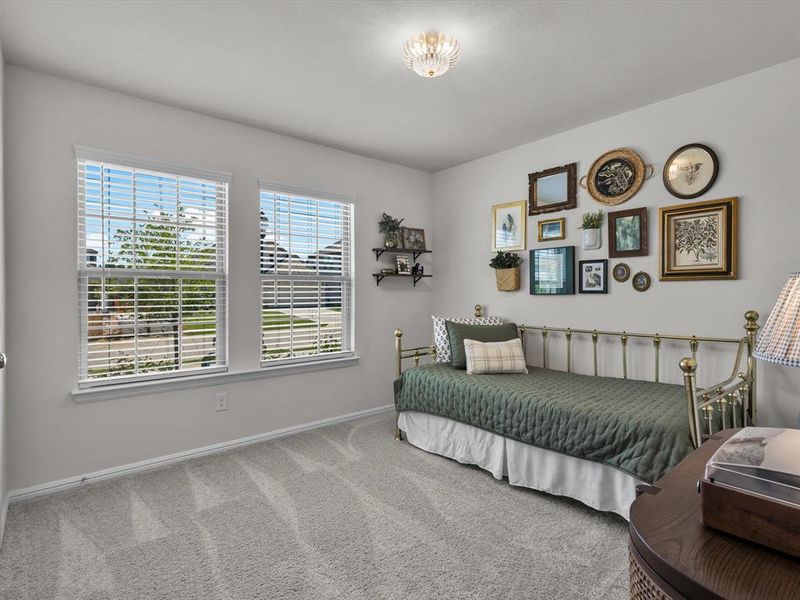 Front secondary bedroom is light and bright with two windows.