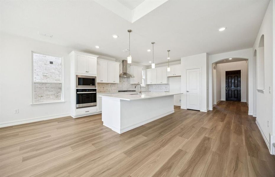 Large island overlooking gathering room and dining areas Large island overlooking gathering room and dining areas