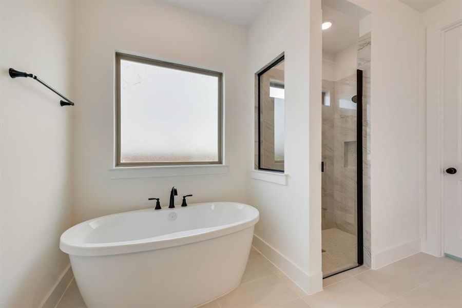 Full bathroom featuring a stall shower, a freestanding bath, tile patterned flooring, and recessed lighting