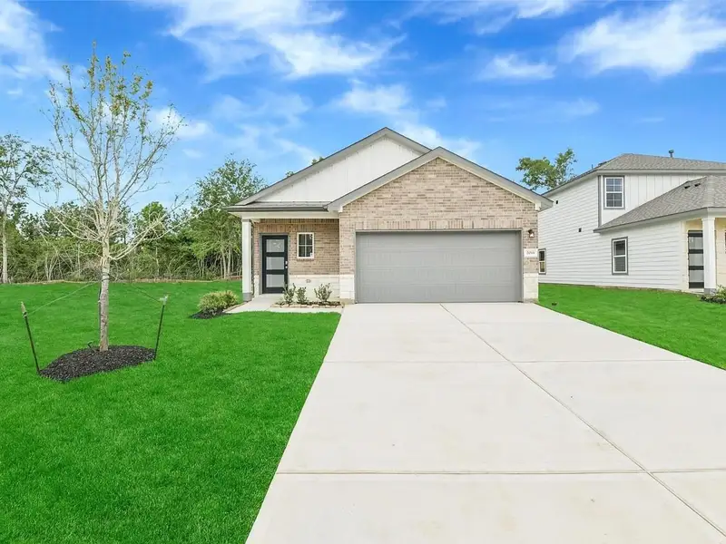 Front exterior of a new home in Caney Creek Place, Conroe, TX, highlighting curb appeal (Image 2). Front exterior of a new home in Caney Creek Place, Conroe, TX, highlighting curb appeal (Image 2).