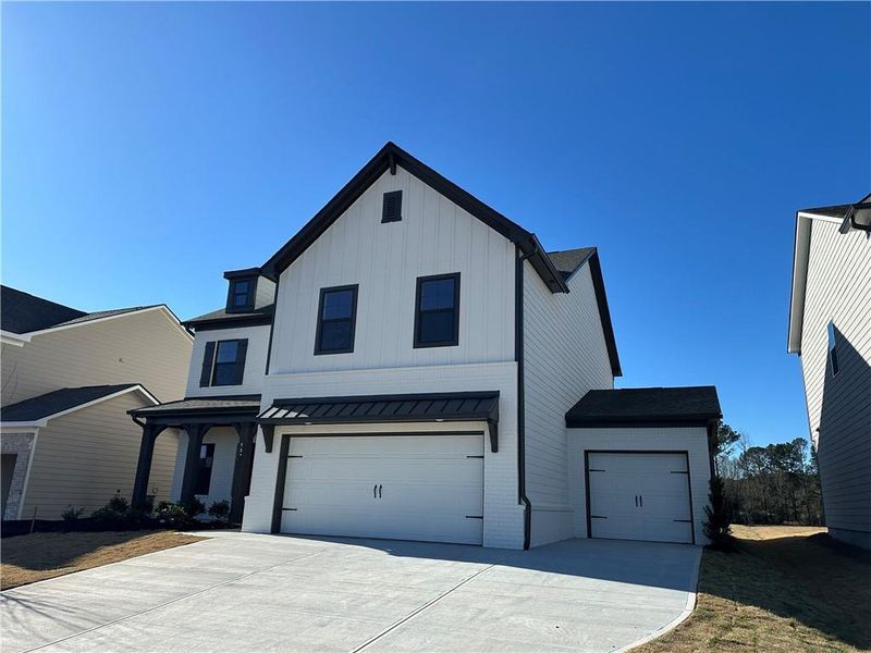 Front exterior of a new home in Summerlin, Winder, GA, highlighting curb appeal (Image 24).