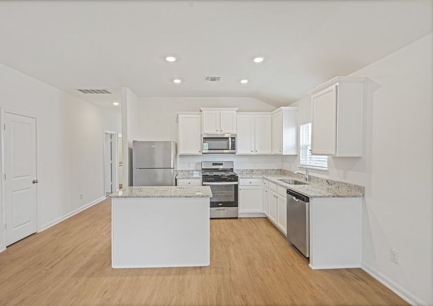 Kitchen with grey granite countertops and stainless steel appliances
