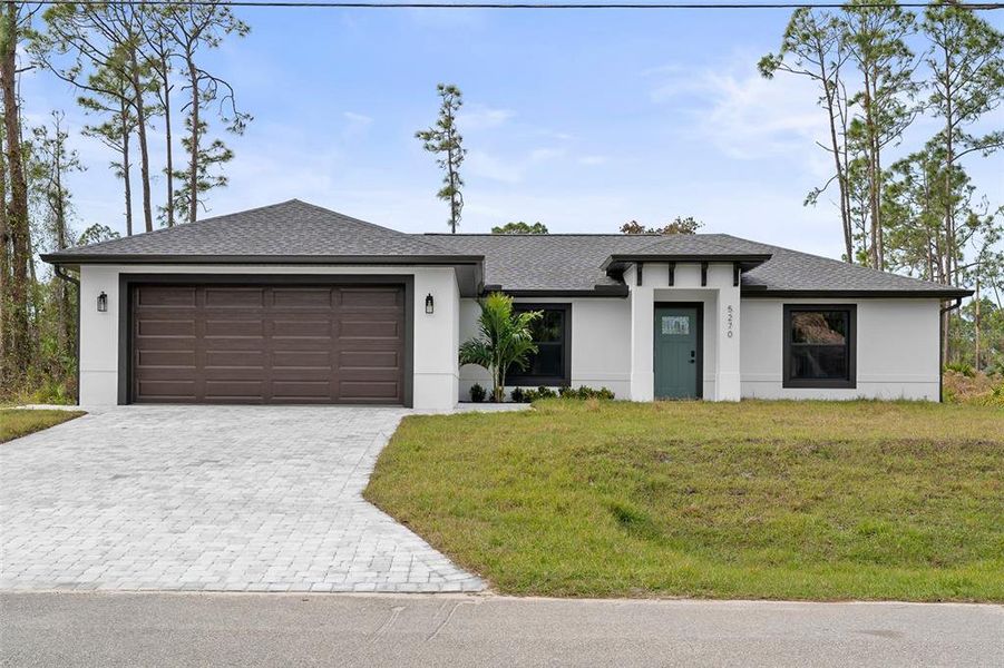 Front exterior of a new home in , North Port, FL, highlighting curb appeal (Image 1). Front exterior of a new home in , North Port, FL, highlighting curb appeal (Image 1).