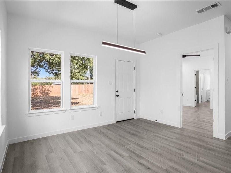 Unfurnished dining area featuring hardwood / wood-style flooring