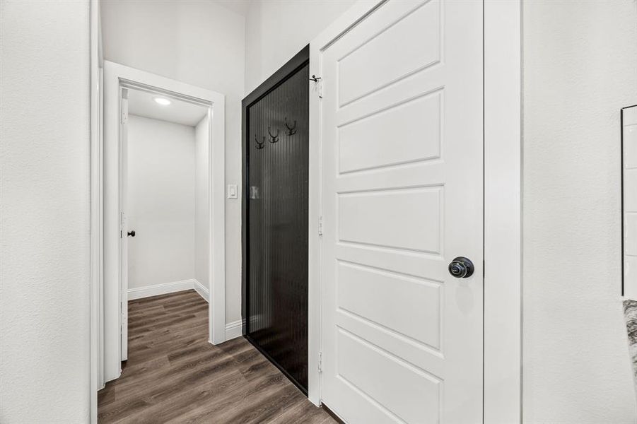 Corridor with dark hardwood / wood-style flooring