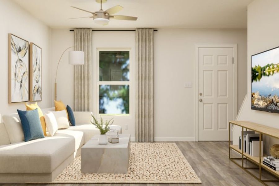 A living room with a white couch and a fan. A living room with a white couch and a fan.