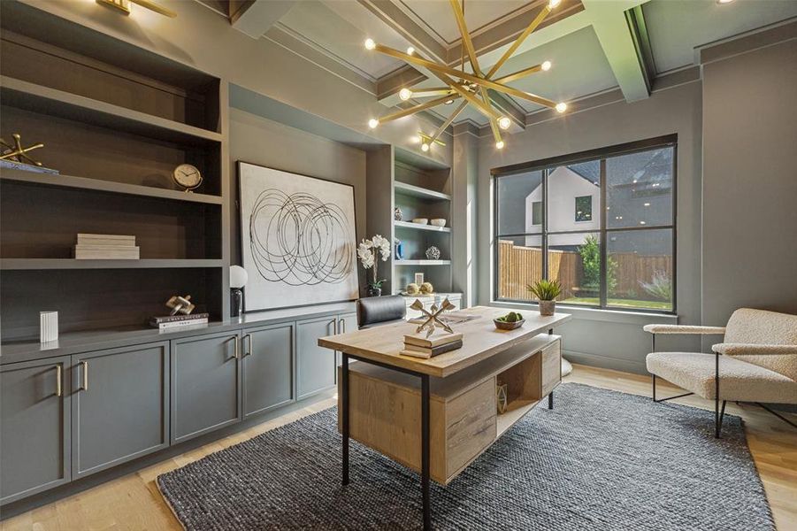 Spacious room featuring light wood-finish flooring, a coffered ceiling, and a large window with black framing Spacious room featuring light wood-finish flooring, a coffered ceiling, and a large window with black framing