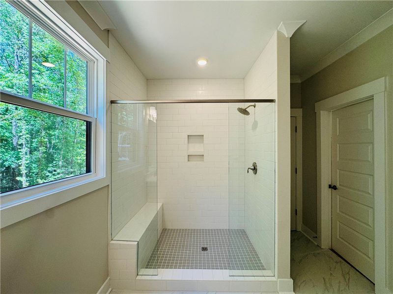 This spacious shower features pristine tile work a